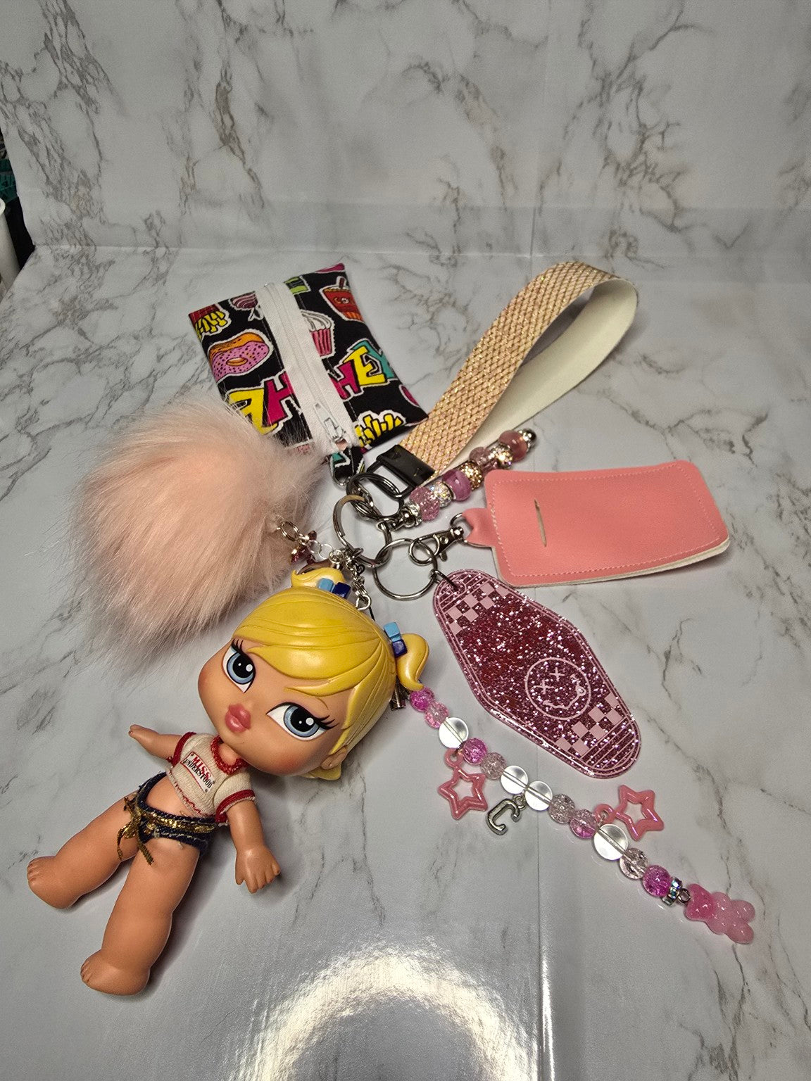 Pink handmade keychain accessory set with doll charm and beaded details